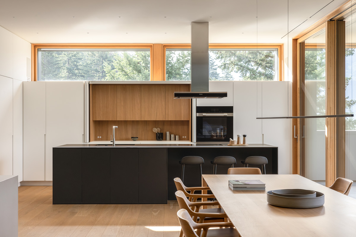 integrated appliances and custom kitchen millwork that open to reveal the main workspace